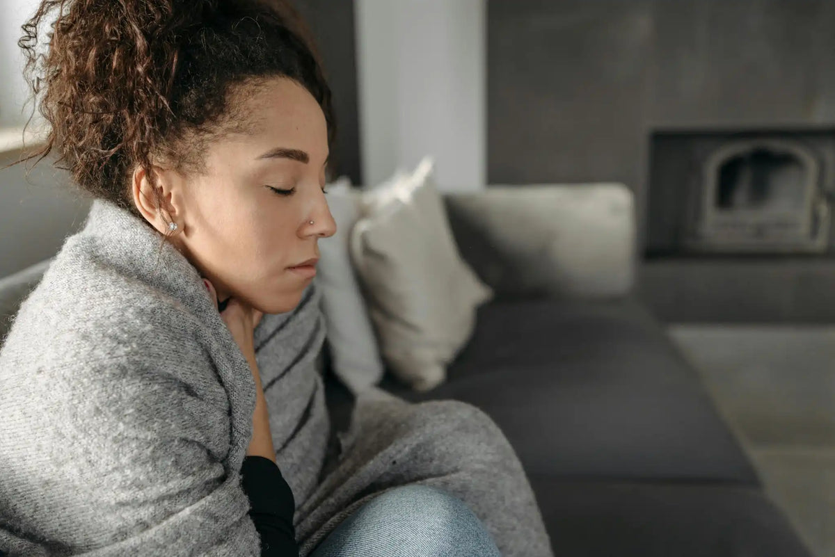 a woman facing hot flashes as part of her menopausal symptoms
