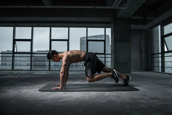 Man working out with muscles visibly strained, demonstrating the physical stress that leads to muscle recovery processes.
