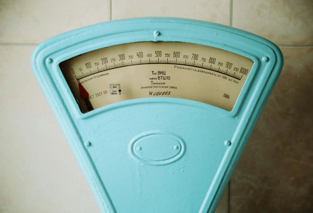 Weighing scale representing genetic impact on body weight and metabolism