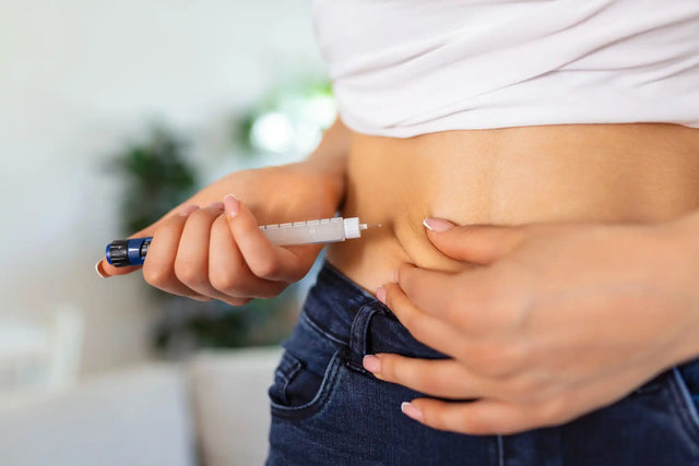 a woman using an insulin pen