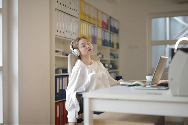 Person resting at desk after lunch, symbolizing afternoon energy dip