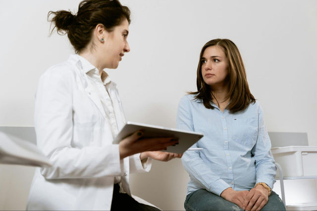Doctor discussing results with patient during consultation, reflecting the question is genetic testing worth it 